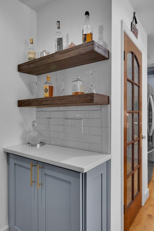 6112 Frontier Ct, Nashville, TN 37211 - bar featuring decorative backsplash and light wood finished floors