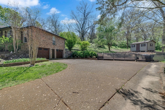 6112 Frontier Ct, Nashville, TN 37211 - view of property exterior featuring fence, aphalt driveway, brick siding, and a garage