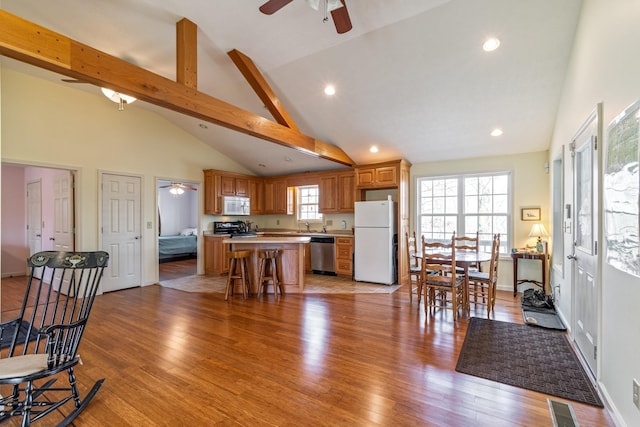 283 Dyestone Springs Rd, Hohenwald, TN 38462 - kitchen with white appliances, ceiling fan, a center island, high vaulted ceiling, and light countertops