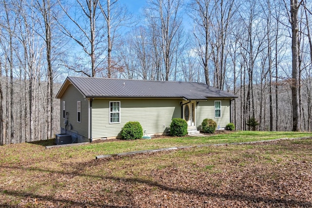 283 Dyestone Springs Rd, Hohenwald, TN 38462 - view of side of home featuring metal roof, a yard, crawl space, and cooling unit