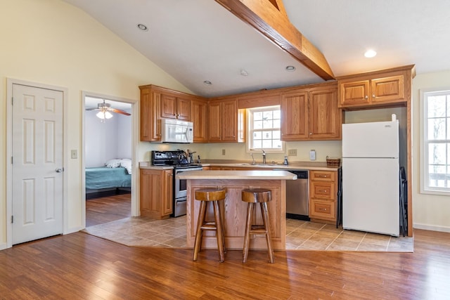283 Dyestone Springs Rd, Hohenwald, TN 38462 - kitchen with appliances with stainless steel finishes, light countertops, lofted ceiling, light wood finished floors, and recessed lighting