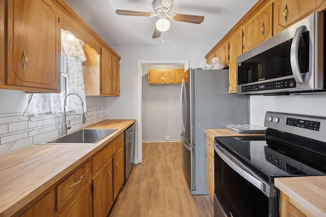 130 Gail St, Oak Grove, KY 42262 - kitchen with wood counters, ceiling fan, stainless steel appliances, decorative backsplash, and a sink