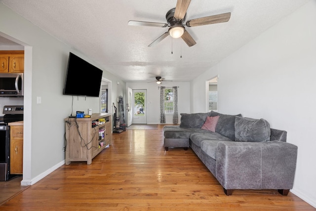 130 Gail St, Oak Grove, KY 42262 - living room with baseboards, light wood-type flooring, a ceiling fan, and a textured ceiling