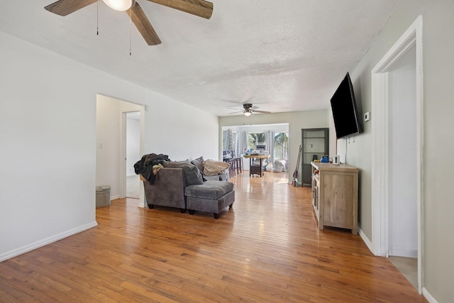 130 Gail St, Oak Grove, KY 42262 - living area featuring light wood-style flooring, a textured ceiling, baseboards, and ceiling fan
