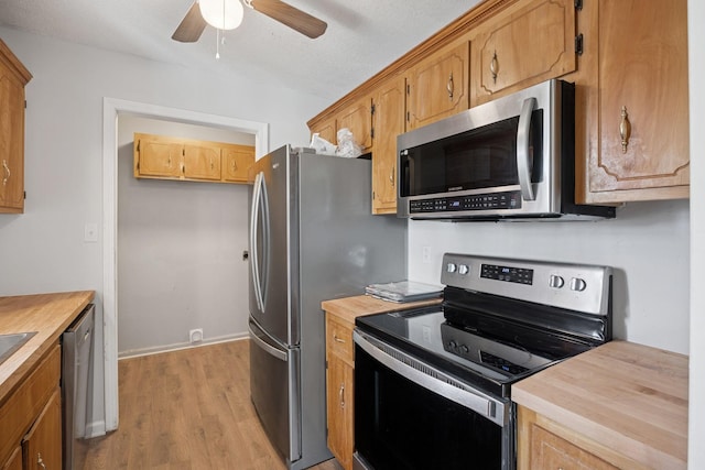 130 Gail St, Oak Grove, KY 42262 - kitchen featuring baseboards, light wood-style flooring, a ceiling fan, wooden counters, and stainless steel appliances