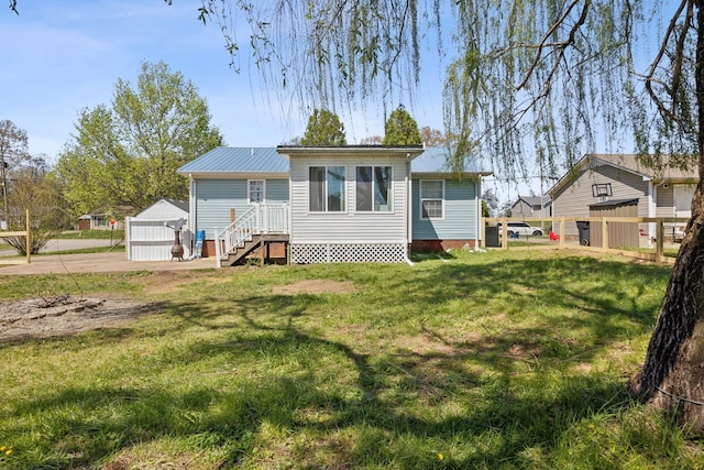 130 Gail St, Oak Grove, KY 42262 - rear view of house with crawl space, a yard, metal roof, and fence