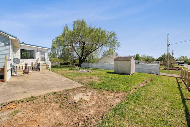 130 Gail St, Oak Grove, KY 42262 - view of yard featuring a patio area, entry steps, a fenced backyard, an outbuilding, and a storage unit