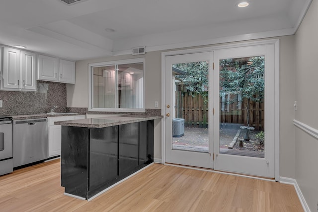 5025 Hillsboro Pike Unit 22D, Nashville, TN 37215 - kitchen featuring light wood-style floors, stainless steel dishwasher, white cabinetry, and backsplash
