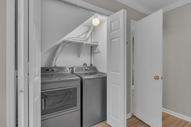 5025 Hillsboro Pike Unit 22D, Nashville, TN 37215 - laundry room with baseboards, light wood-type flooring, crown molding, laundry area, and washing machine and clothes dryer