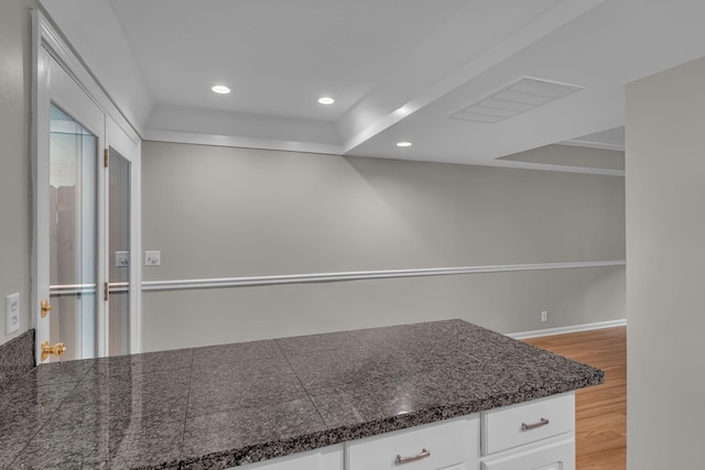 5025 Hillsboro Pike Unit 22D, Nashville, TN 37215 - kitchen with recessed lighting, white cabinets, visible vents, tile countertops, and wood finished floors