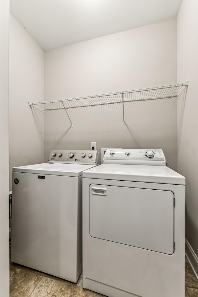laundry room with separate washer and dryer and laundry area