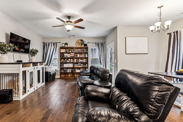 living room with ceiling fan with notable chandelier and wood-type flooring