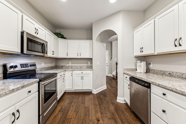 kitchen featuring dark wood-style flooring, white cabinetry, and stainless steel appliances