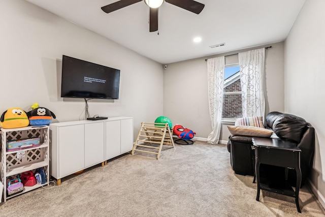 recreation room featuring carpet, visible vents, baseboards, and a ceiling fan