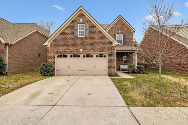 view of front of property with concrete driveway, a front yard, brick siding, and an attached garage