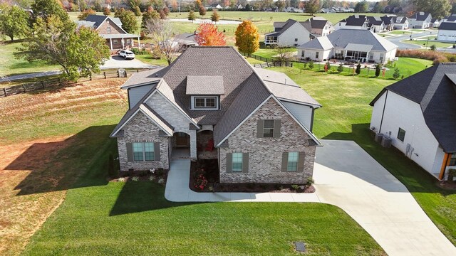 405 Sheas Way, Clarksville, TN 37043 - view of front of home featuring a residential view, brick siding, driveway, roof with shingles, and a front lawn