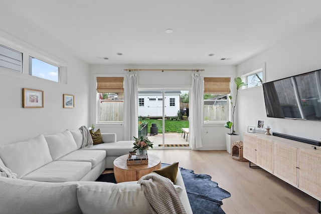 living room with recessed lighting, visible vents, and light wood-type flooring