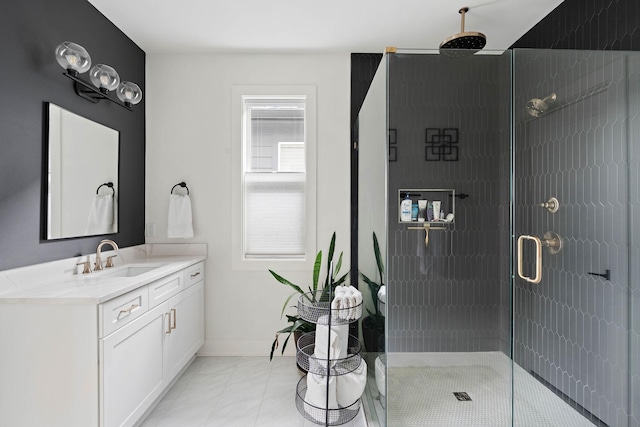 full bath with a shower stall, vanity, and baseboards