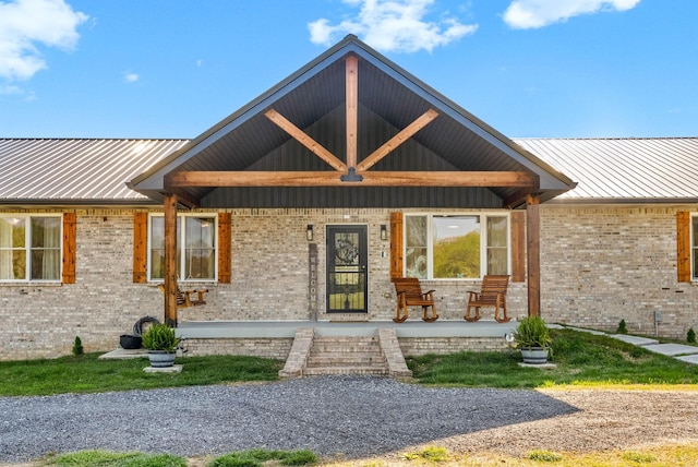 779 Iron Workers Rd W, Clarksville, TN 37043 - exterior space with brick siding, metal roof, and covered porch