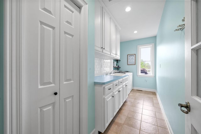 779 Iron Workers Rd W, Clarksville, TN 37043 - laundry room featuring a sink, baseboards, recessed lighting, and light tile patterned floors