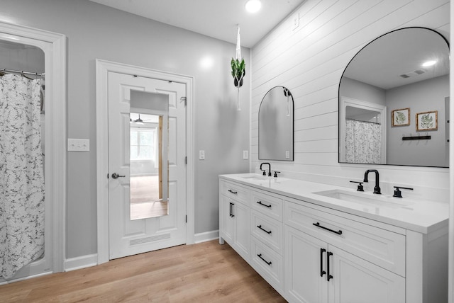 779 Iron Workers Rd W, Clarksville, TN 37043 - full bath featuring wood finished floors, a sink, visible vents, and double vanity