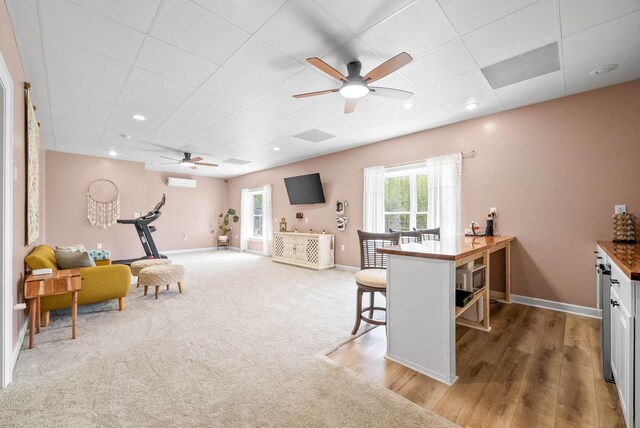 779 Iron Workers Rd W, Clarksville, TN 37043 - interior space with a paneled ceiling, a wall mounted AC, ceiling fan, and a healthy amount of sunlight