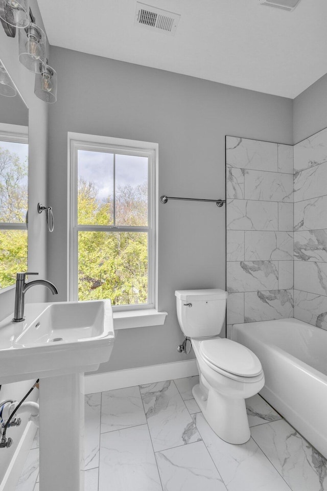 1617 Adams St, Chattanooga, TN 37408 - full bath with visible vents, toilet, marble finish floor, a sink, and baseboards