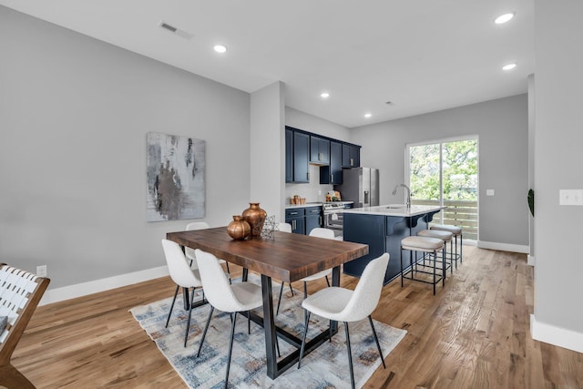 1617 Adams St, Chattanooga, TN 37408 - dining room with light wood-style floors, baseboards, and visible vents