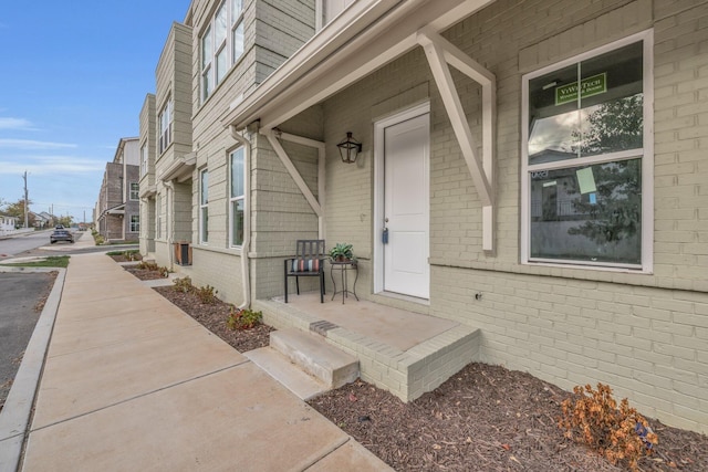 1617 Adams St, Chattanooga, TN 37408 - view of exterior entry featuring brick siding and a porch