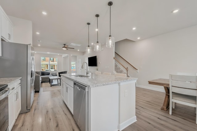 162 Jackson Alan Dr, Murfreesboro, TN 37130 - kitchen with stainless steel appliances, a ceiling fan, open floor plan, light wood-type flooring, and white cabinets