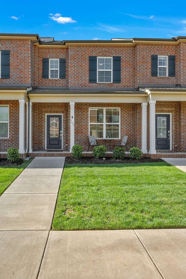 162 Jackson Alan Dr, Murfreesboro, TN 37130 - view of property with brick siding, a porch, and a front yard