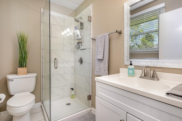 full bathroom with a shower stall, vanity, baseboards, and toilet