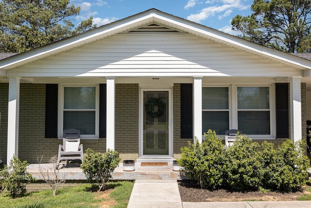 bungalow with brick siding and covered porch