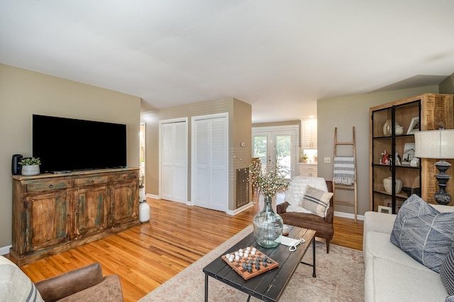 living room featuring light wood-style floors and baseboards