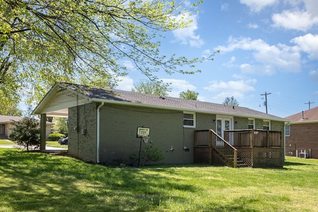 rear view of house featuring central AC, a lawn, stairway, brick siding, and a wooden deck