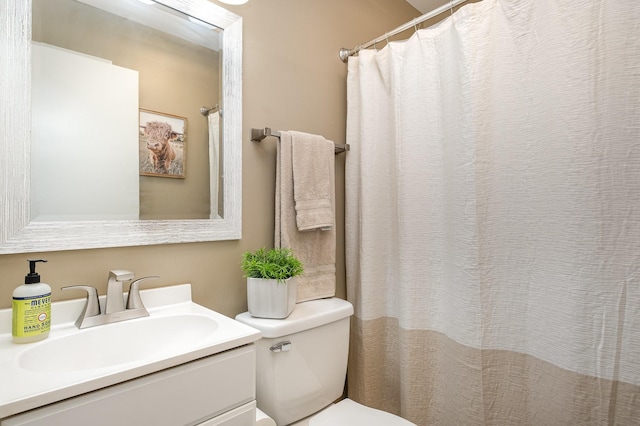 full bathroom featuring toilet, vanity, and a shower with shower curtain