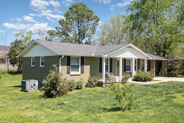 ranch-style home with a shingled roof, brick siding, central air condition unit, and a front lawn