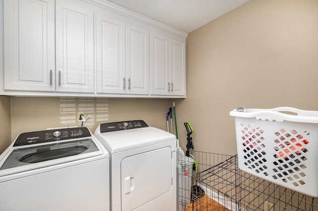 washroom with independent washer and dryer and cabinet space