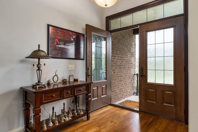 doorway to outside with a wealth of natural light and wood finished floors