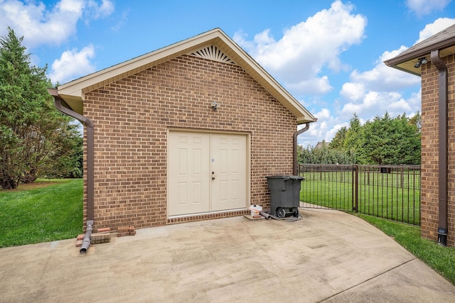 view of outbuilding featuring fence