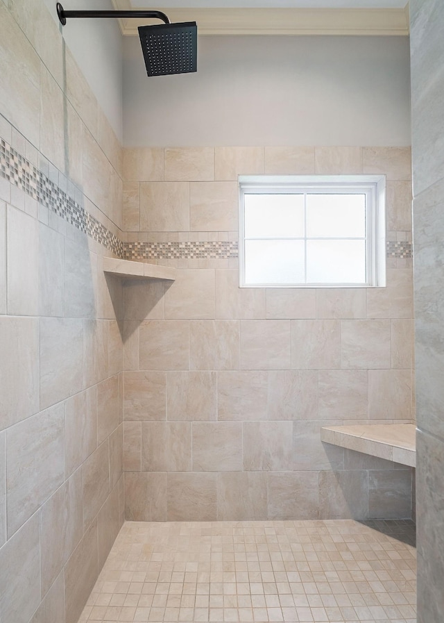 bathroom featuring tiled shower and ornamental molding