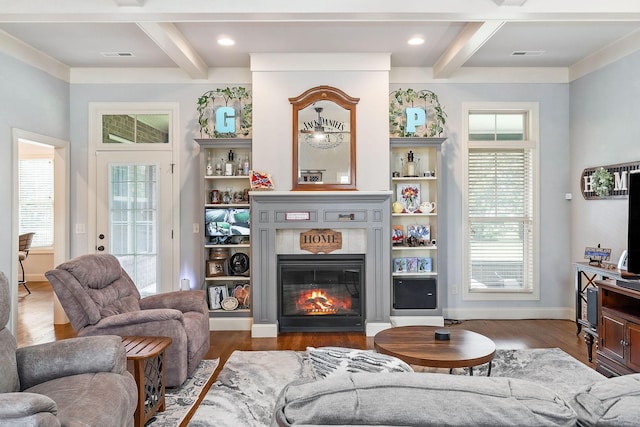 living area with beamed ceiling, plenty of natural light, and coffered ceiling