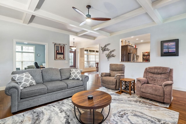living room featuring beamed ceiling, a ceiling fan, coffered ceiling, and wood finished floors