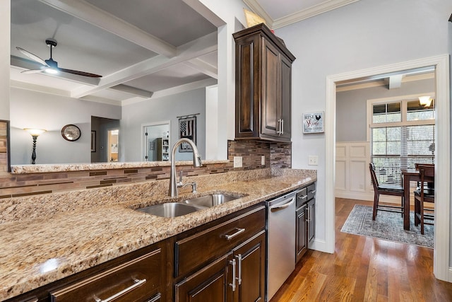 kitchen with dark brown cabinetry, light stone counters, ceiling fan, dishwasher, and a sink