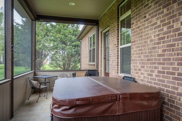 sunroom featuring a hot tub