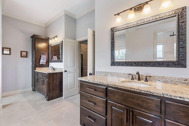 bathroom with baseboards, two vanities, a sink, and ornamental molding