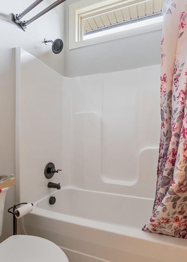 bathroom with shower / bathtub combination with curtain and toilet
