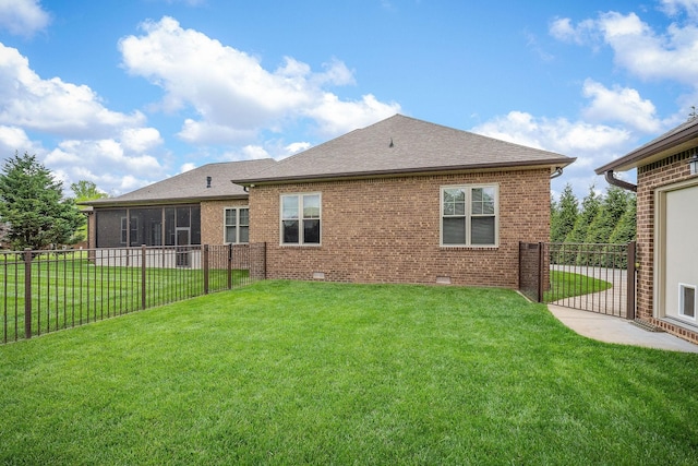 back of property featuring crawl space, a lawn, fence, brick siding, and roof with shingles