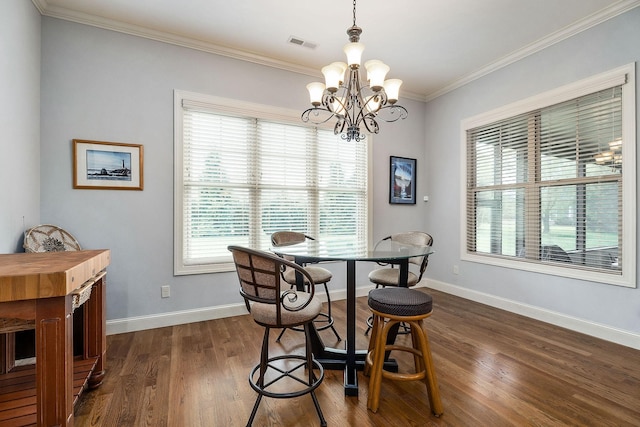 dining area featuring visible vents, baseboards, dark wood-style flooring, a chandelier, and crown molding