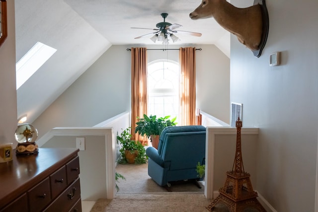 interior space with ceiling fan, light colored carpet, and lofted ceiling